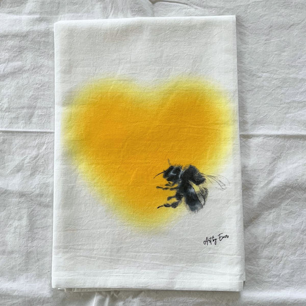 flour sack towel featuring bumble bee feeding at heart shaped yellow flower