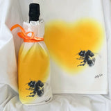 flour sack towel used to wrap a gift featuring bumble bee drawing