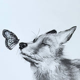 A giclee print of a black and white fox with a butterfly on its nose.